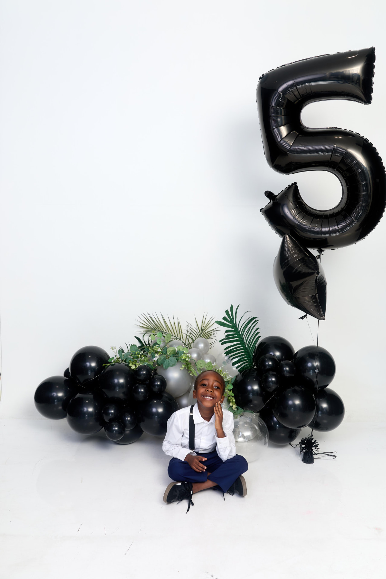 Black and silver balloon installation for a fifth birthday