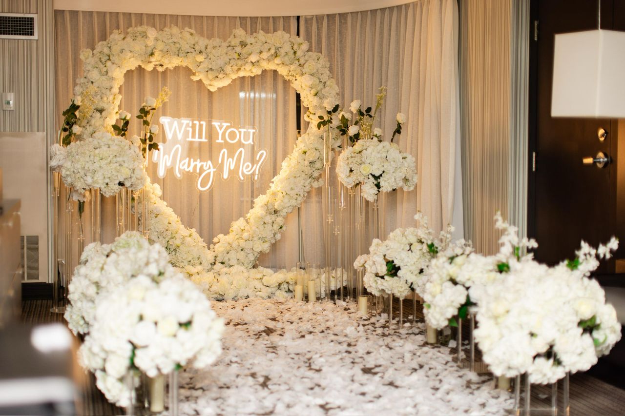 White floral heart with Will You Marry Me neon