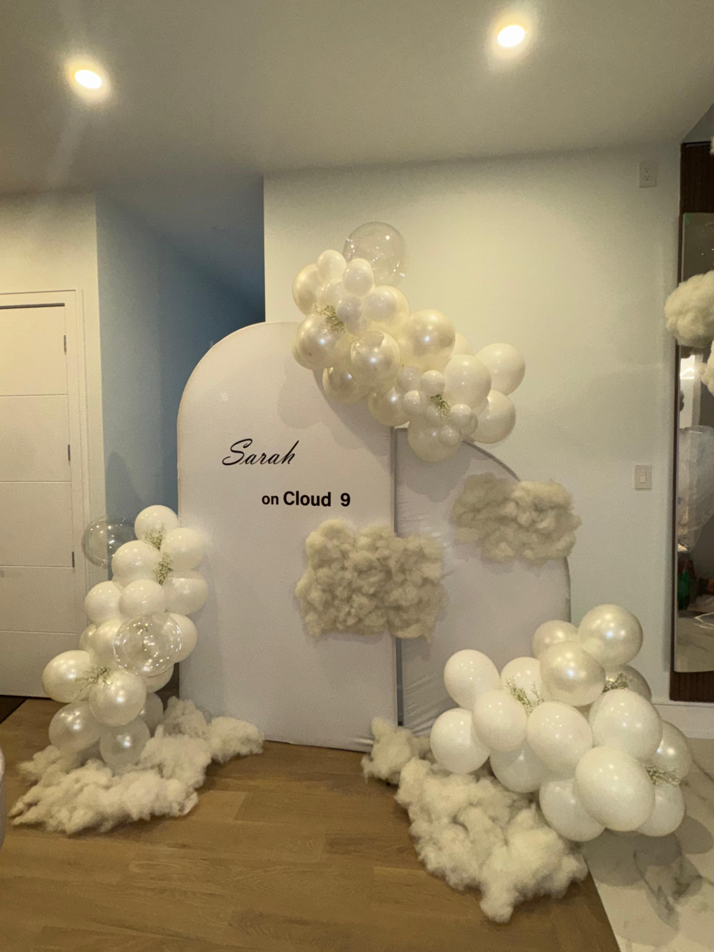 On Cloud 9 arched backdrop with ivory balloon garland